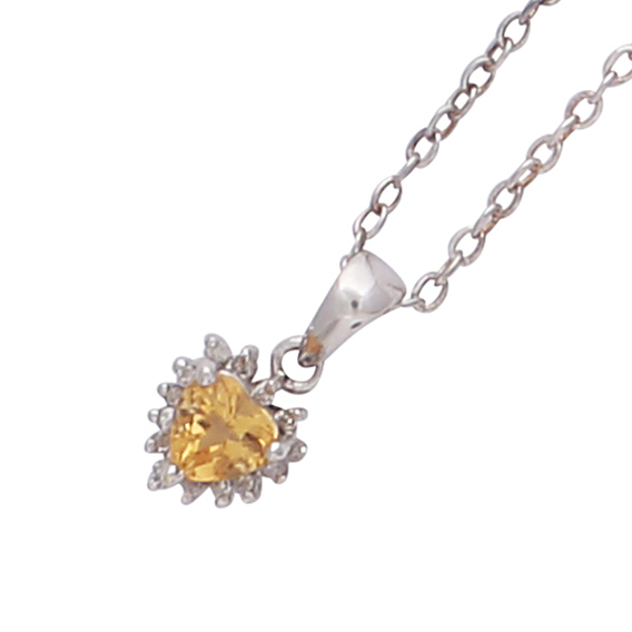 A citrine and diamond heart pendant in 14ct white gold set with a heart cut citrine surrounded by