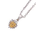 A citrine and diamond heart pendant in 14ct white gold set with a heart cut citrine surrounded by