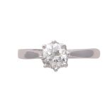 A solitaire diamond engagement ring in 18ct white gold the claw set round cut diamond weighing