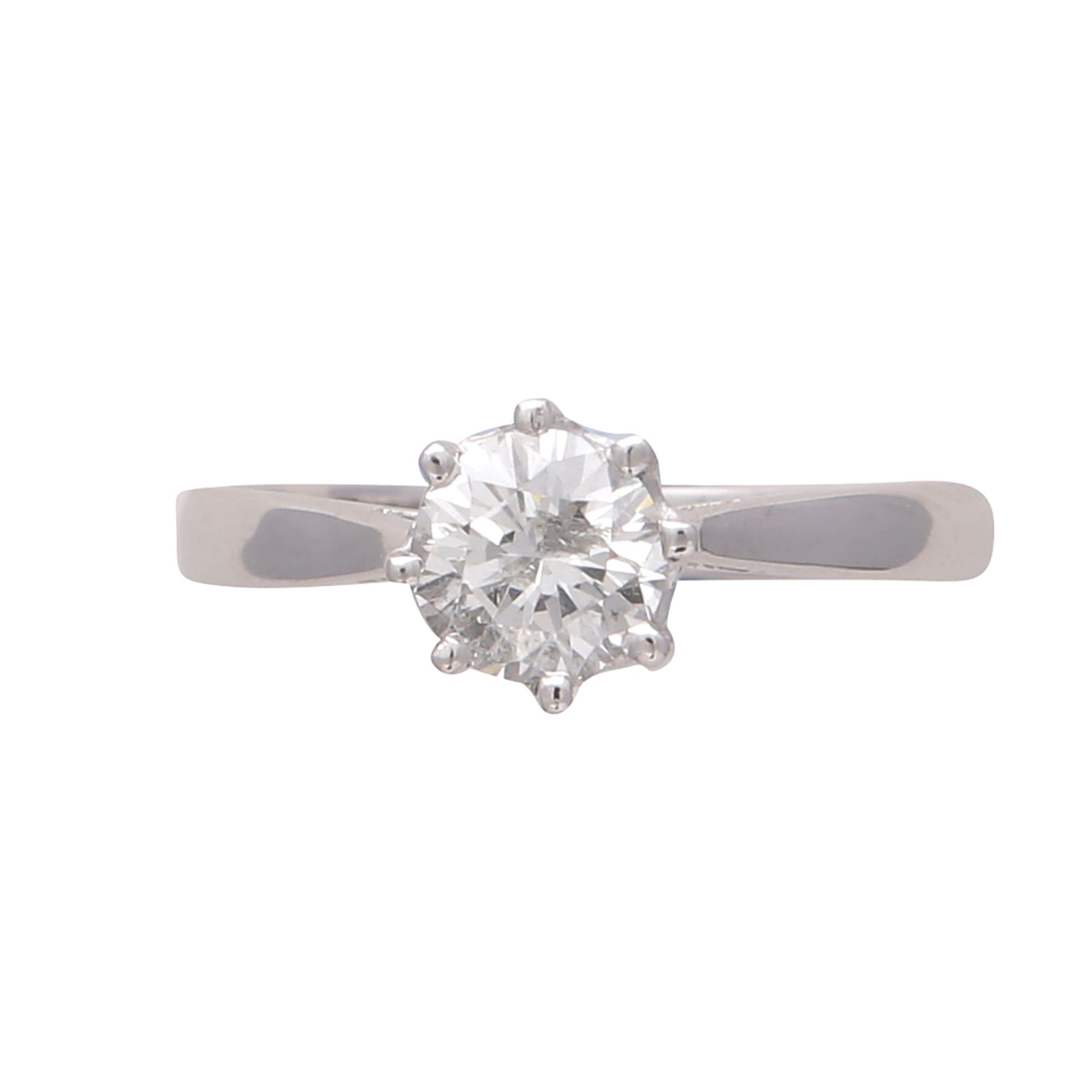 A solitaire diamond engagement ring in 18ct white gold the claw set round cut diamond weighing