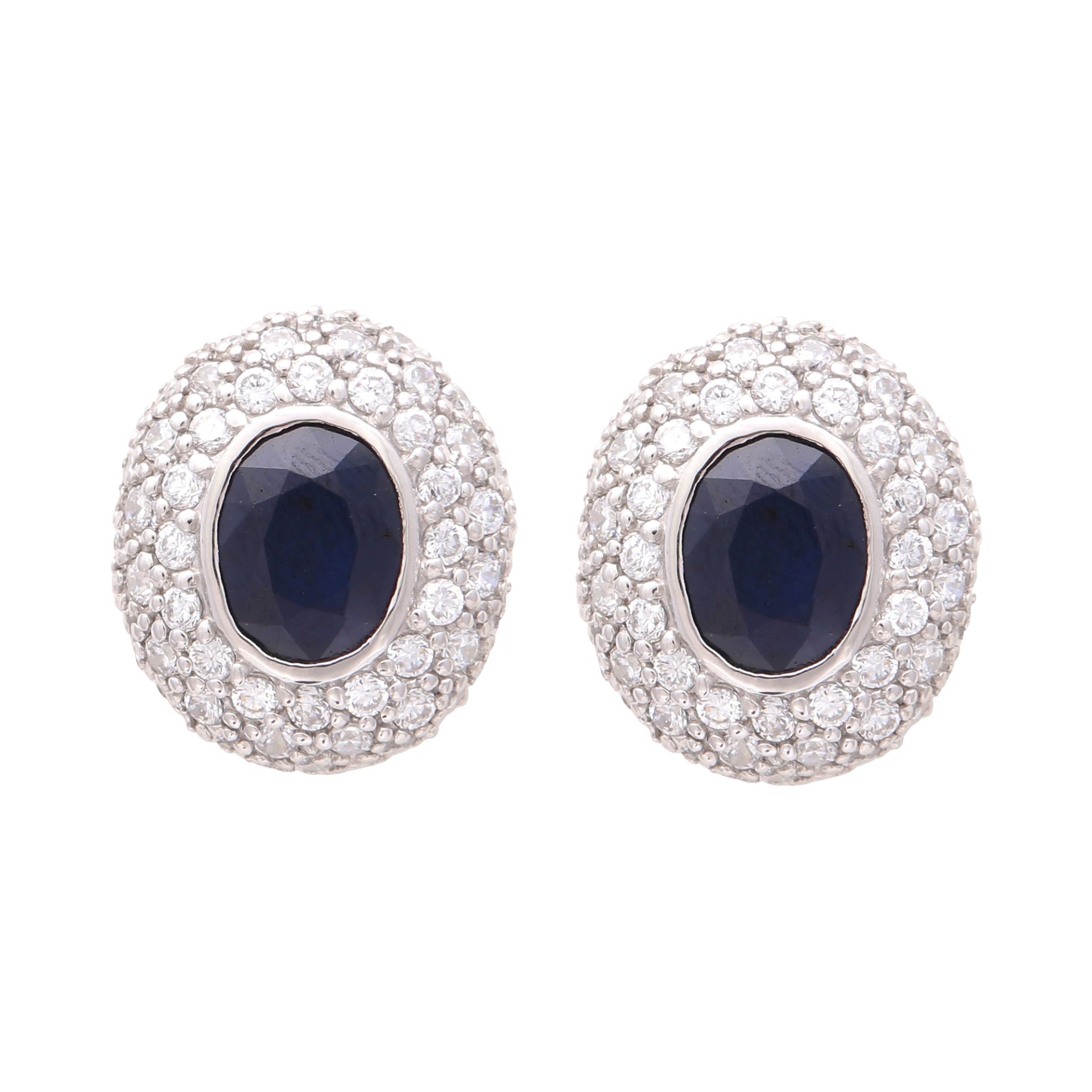 A pair of sapphire cluster earrings in sterling silver, each set with an oval cut sapphire