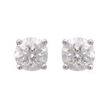 A pair of diamond stud earrings in 18ct white gold each claw set with a round cut diamond. Estimated