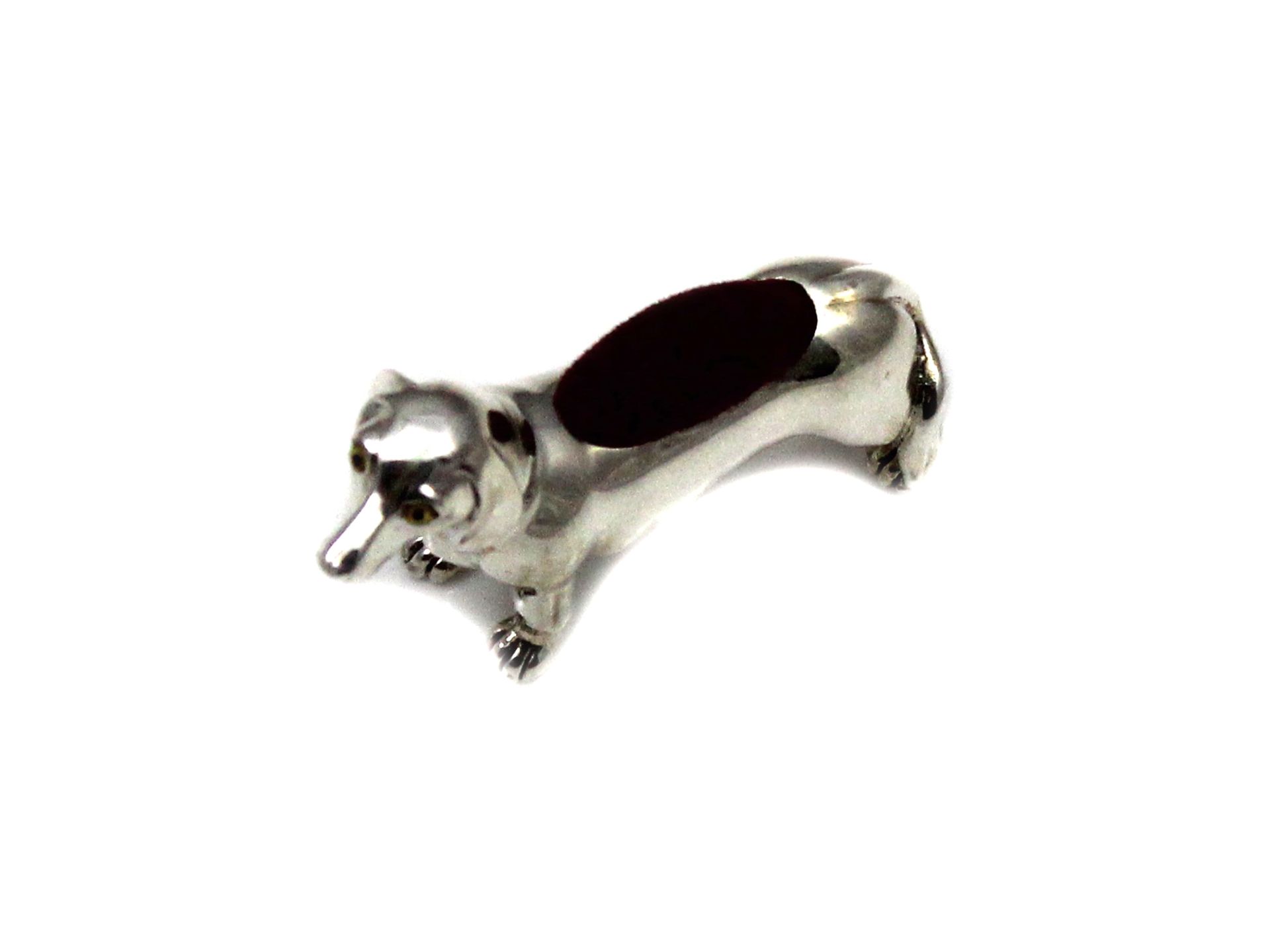 A novelty Sterling Silver miniature dachshund pin cushion. Length 5cm / 2". Gross weight 22.8g.