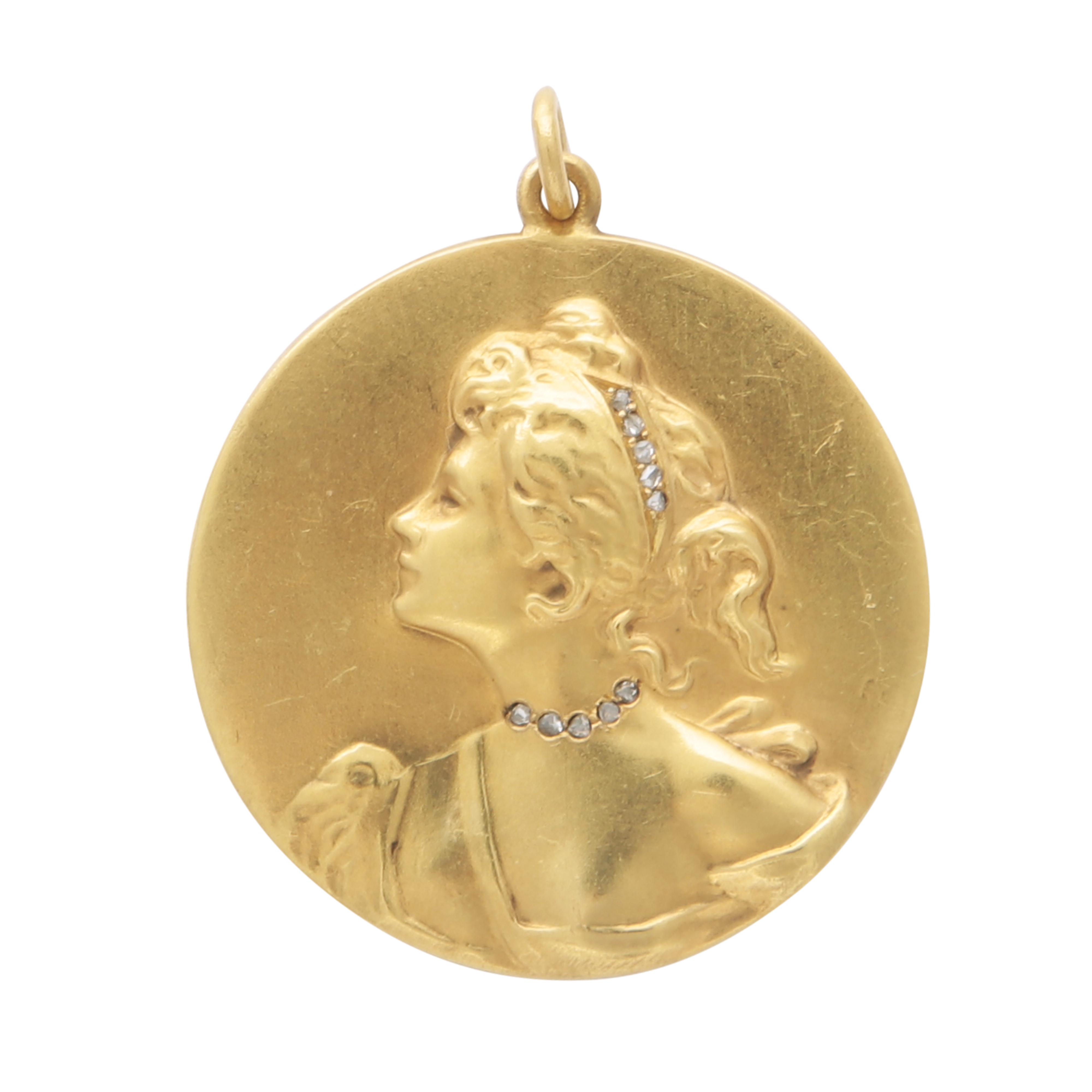 An Art Nouveau jewelled medallion pendant in high carat yellow gold, the circular medallion with