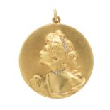 An Art Nouveau jewelled medallion pendant in high carat yellow gold, the circular medallion with
