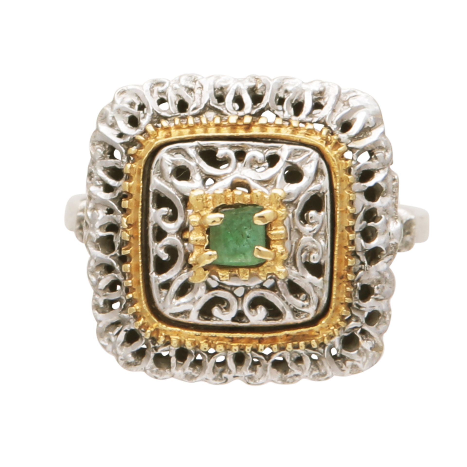 An antique emerald dress ring in 18ct white and yellow gold, the central step cut emerald claw set