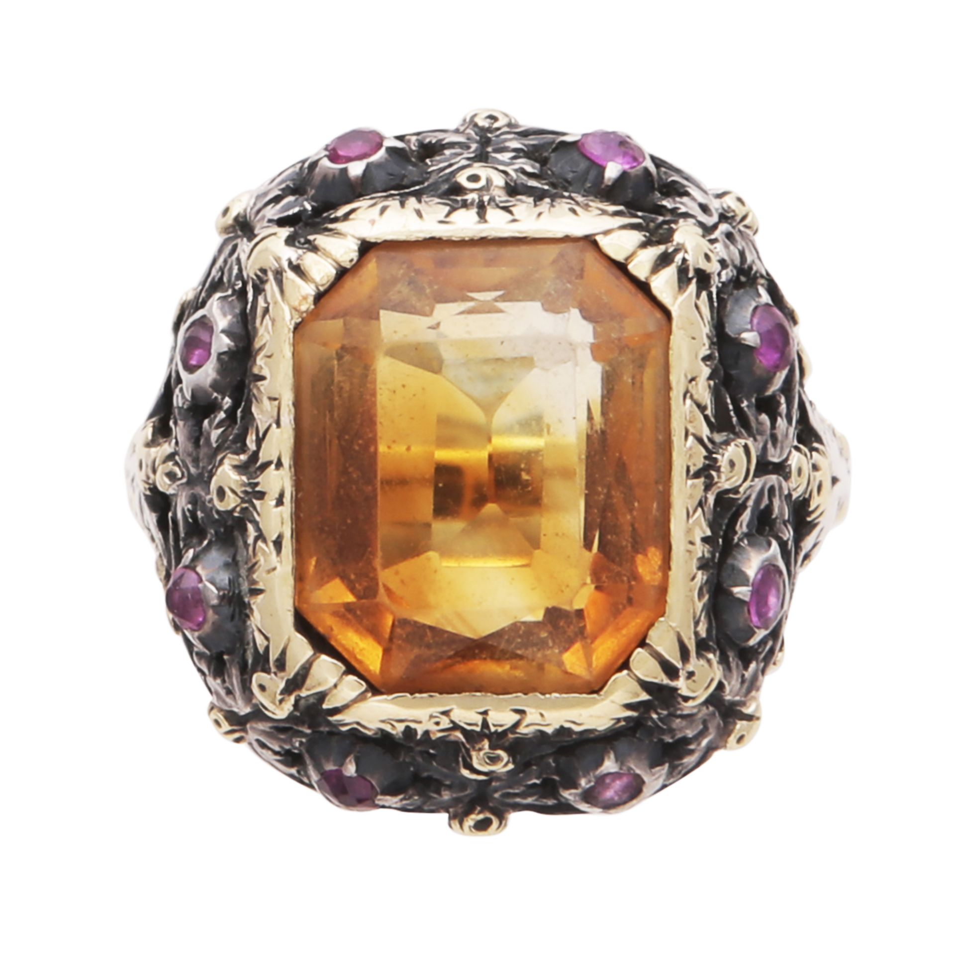 A citrine and ruby dress ring in high carat gold, designed as a large, emerald / scissor cut citrine