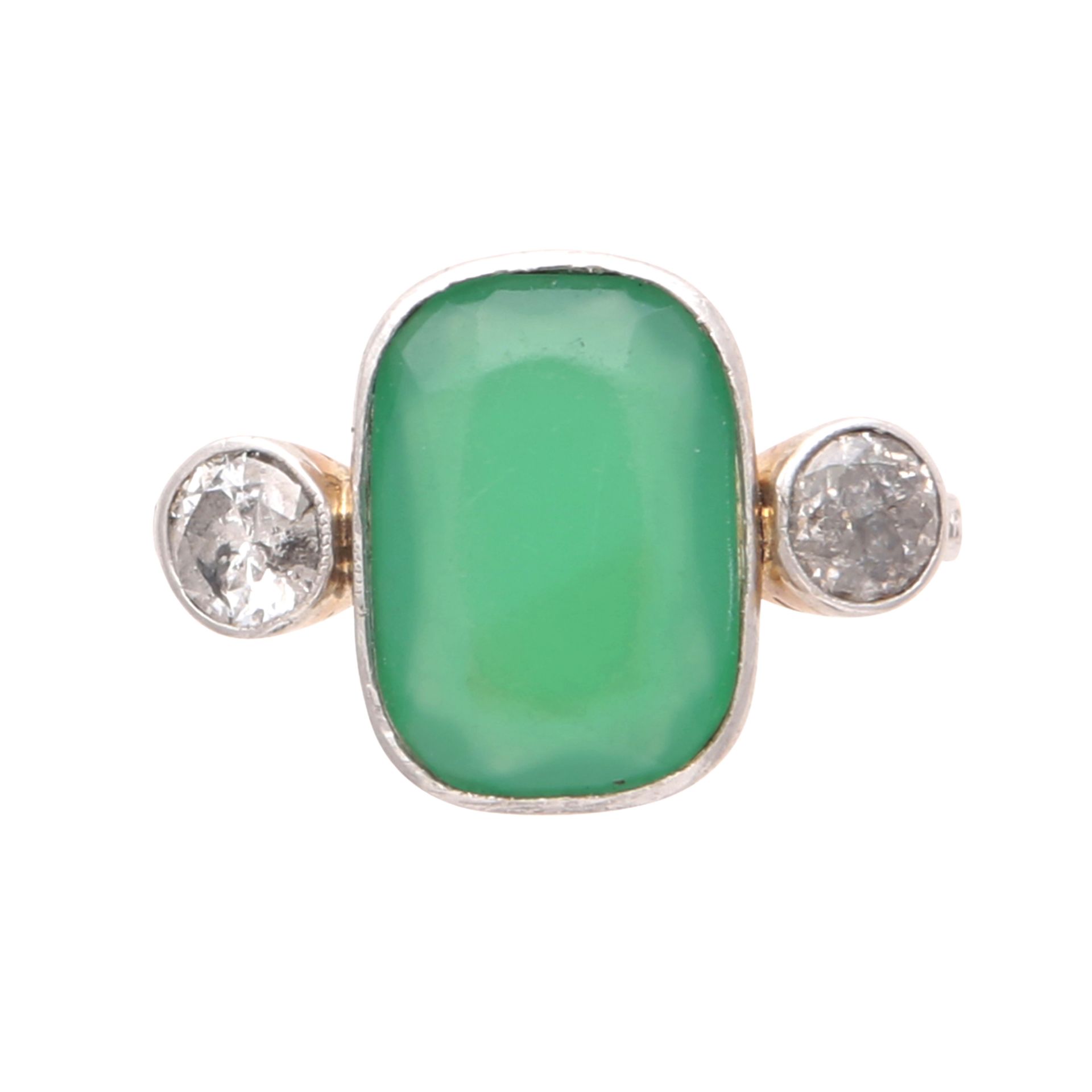 An emerald and diamond dress ring in yellow gold, unmarked, designed as an oval cushion shaped