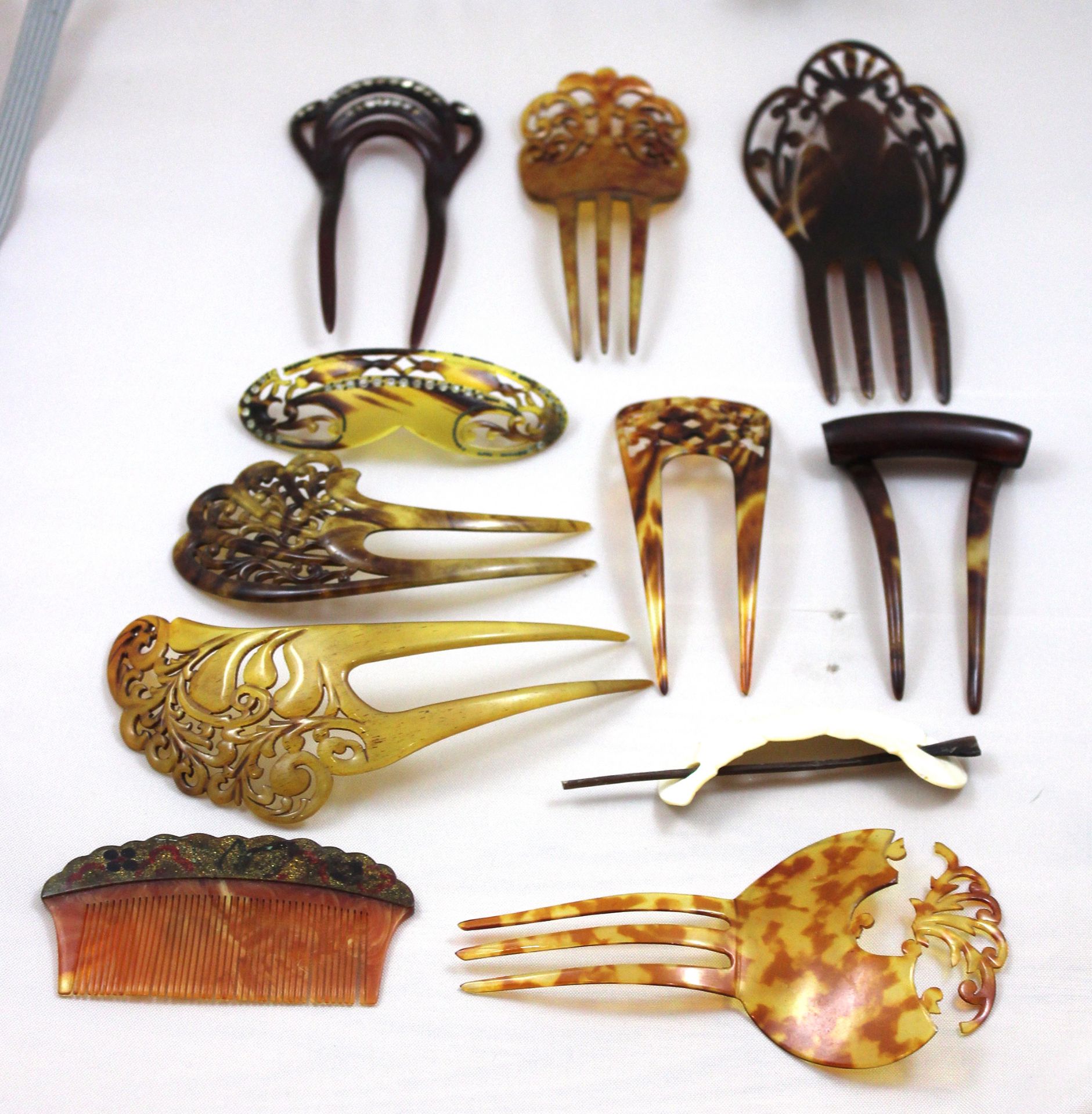 A collection of eleven vintage hair combs carved in various mediums.