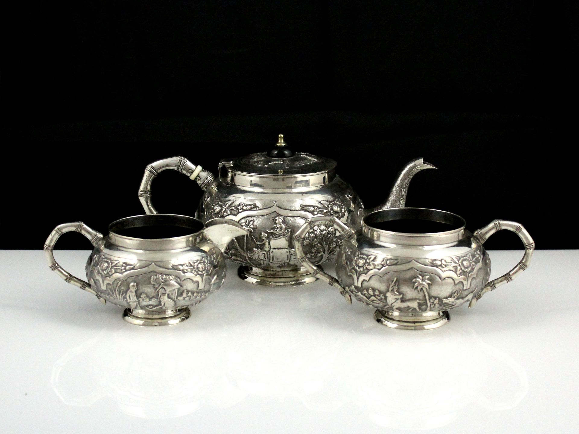 An Antique Colonial Indian Sterling Silver tea set circa 1900. Comprising three pieces, teapot,