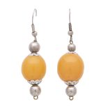 A pair of amber drop earrings in silver each designed as a single oval amber bead with floral silver