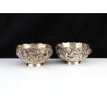 Two Antique Japanese Silver dragon bowls c1900 Each of circular form on a single foot, the bodies