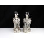 A pair of antique George V sterling silver mounted glug glug decanters by William Comyns, London