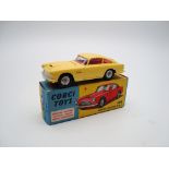 A Corgi Toys Aston Martin DB4 in Primrose yellow with cast criss cross wheels - Very Good - one or