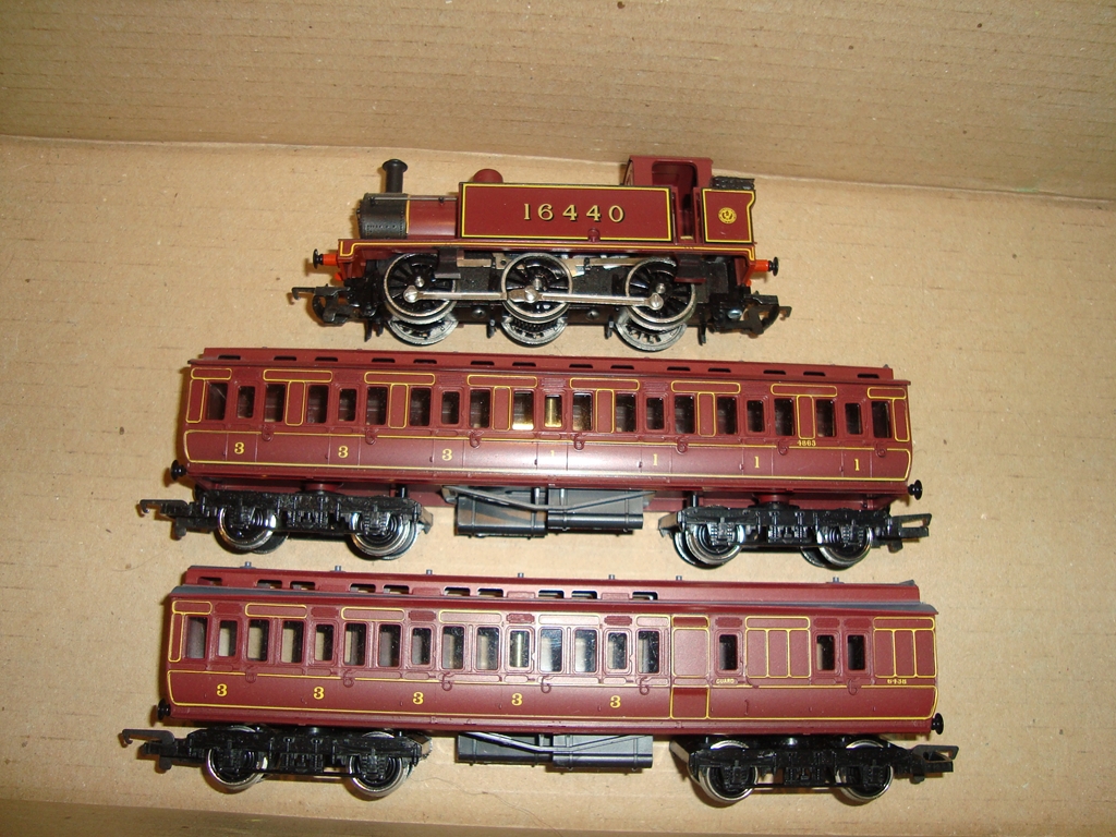 An unboxed Hornby LMS Jinty steam locomotive, together with two Clerestory coaches in similar livery