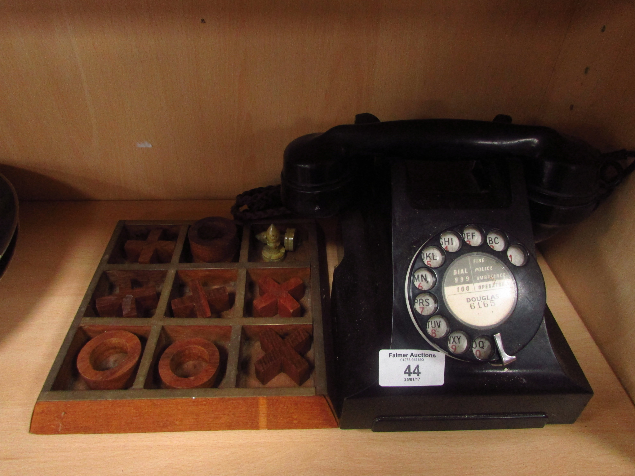 Wooden draught pieces and retro black telephone