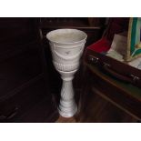 White ceramic plant stand and pot