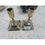 Pair of early brass candle sticks on square bases