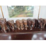 7 carved wood elephants