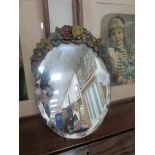 Oval mirror on stand flower decoration on top