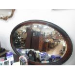 Oval wood framed mirror