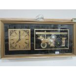 Framed quartz clock with traction engine
