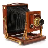 A Camera Construction Co. 'The Falcon' Half Plate Mahogany Field Camera,