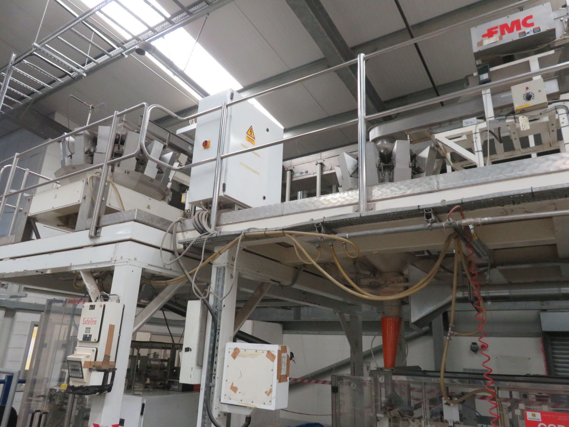 A complete packing line: FMC Foodtech vibratory feeder 2mtr x 300mm wide, FMC bucket elevator 5 mtr