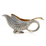 A silver coloured swan shaped sauce boat and sauce ladle