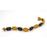 Bracciale in oro giallo con smalti e turchesi A gold, enamel and turquoise bracelet