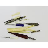 A small collection of bone handled glove stretchers and files, together with a silver pencil etc.