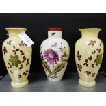 A pair of opaque glass baluster vases painted with flowers in coloured enamels together with a white