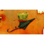 A vintage crocodile skin handbag and a leather handled and gilt metal mounted umbrella (2)