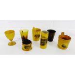 A collection of six Mauchline ware items to include an egg cup, beaker, churn, needle case, pin