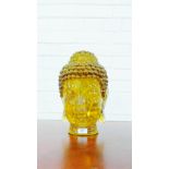 An amber glass Buddha head, 35cm high