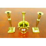 A brass mortar and pestle and a pair of brass candlesticks, (4)