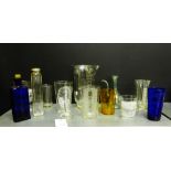 A quantity of vintage glass measuring jars and pourers together with a blue glass poison bottle, a