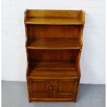 An Ercol light elm bookcase, fitted two shelves and a pair of cupboard doors to the base, 111 x 61cm