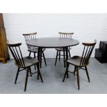 A retro dining suite comprising circular drop flap table and set of four stick back chairs, paper