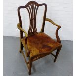 A mahogany open arm chair, with leather slip seat, raised on tapering square supports and spade