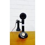 A vintage black Bakelite candlestick telephone