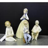 A collection of three NAO Spanish porcelain figures and another similar, tallest 28cm, (4)