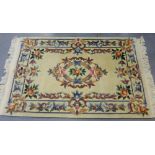 A pale yellow rectangular Chinese wool rug,