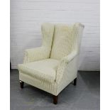 An upholstered wing armchair, 102 x 78cm