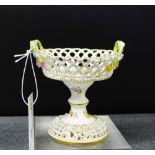 A miniature Meissen basket comport on stand with floral encrusted decoration and painted with