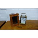 A small brass carriage clock with outer leather carry case