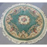 A pale green circular Chinese wool rug, 150cm diameter