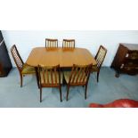 A teak dining suite comprising oval table and set of six splat back chairs (7)