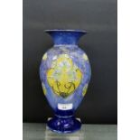 A Royal Doulton blue glazed baluster vase decorated with blue iris floral panels, impressed marks to