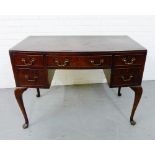 A walnut desk, the rectangular top over an arrangement of five drawers, raised on cabriole supports,